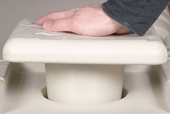 SLXWavePort_Snap-InCap A hand presses down on a white, square Port Snap-in Cap fitted onto a round container opening.